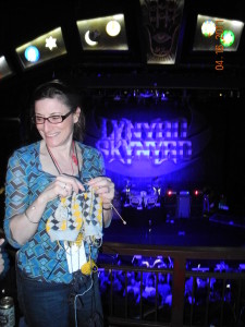This is me, in 2011, knitting a pair of argyles 2-at-a-time, at a Lynyrd Skinner concert. All the yarn I need for both socks is hanging from the needles.