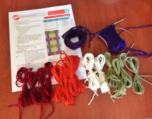 Yarn supplies, from left to right, are A, B, C and D, with the MC small sections wound above them  The cuff is knit, with the MC, on a 24" circular needle, using Magic Loop method.  I'm ready to knit Row 1 of the chart!