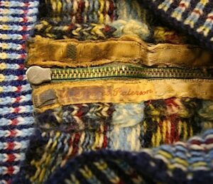 What is N. Patteron's story? TEX1996-22 owner's name on back neck zip. Back neck steek visible.